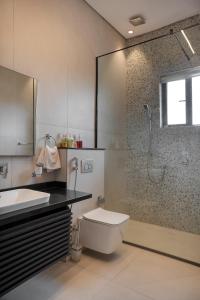 a bathroom with a shower and a toilet and a sink at 108 Opebi Executive Apartments in Lagos
