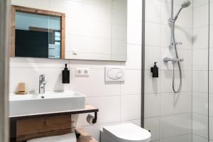 a bathroom with a sink and a shower at SEKRA Stadthotel in Heidenheim an der Brenz +82 photos