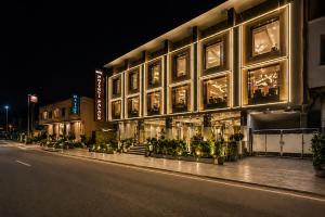 a building on a city street at night at Hotel The Prithvi Delhi Airport With Free Airport Pic Up in New Delhi