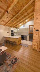 a large kitchen with a large island in a room at كوخ الجنة in Abha