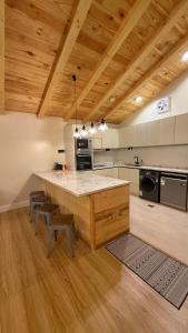 a large kitchen with a large wooden table and chairs at كوخ الجنة in Abha +57 photos