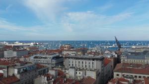 an aerial view of a city with buildings and ships at La Finestra Sul Mare in Trieste