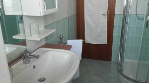 a bathroom with a sink and a shower at La Finestra Sul Mare in Trieste +11 photos
