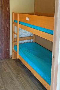 a room with two bunk beds with blue sheets at Résidence Pierre & Vacances Ty Mat in Saint Malo +11 photos