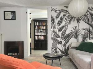 a living room with a couch and a plant wall at Appartement cosy Rosheim in Rosheim