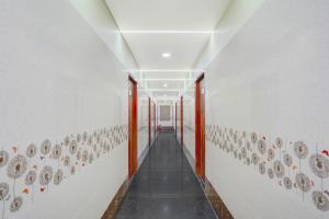 a hallway with plates on the walls of a building at Super Hotel O Magunta Layout Nellore Formerly The Paradise Guest Inn in Nellore