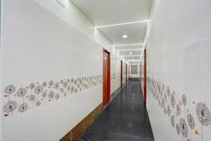 a hallway with plates on the wall in a building at Super Hotel O Magunta Layout Nellore Formerly The Paradise Guest Inn in Nellore