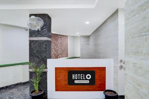a lobby with a hotel sign on a wall at Super Hotel O Magunta Layout Nellore Formerly The Paradise Guest Inn in Nellore