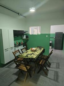 a kitchen with a table and chairs in a room at Pousada Hostel Beach Pajuçara in Maceió