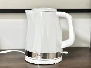 a white tea kettle sitting on a table at Hotel Suite 24 in Warabi