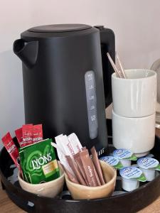 a table with a toaster and a plate of food at Balreask Bar, Restaurant & Guest Accommodation in Navan