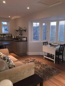 a living room with a couch and a table at Copper's Cottage in Sheringham +14 photos