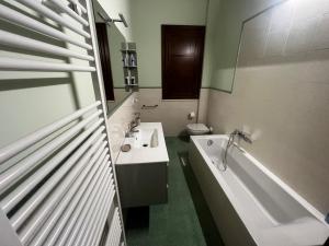 a bathroom with a sink and a tub and a toilet at Antico Granaio di LEO Via Antonia 60 in Ponte Pattoli +11 photos