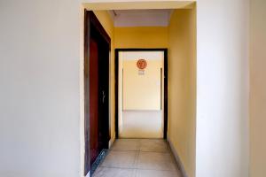 an empty hallway with a door leading to a room at Super Hotel O Sankaradeva Kalakshetra Formerly HK Residency in Dispur