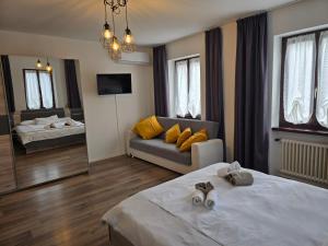 a hotel room with two beds and a couch at La Locanda del Gusto in Cadro