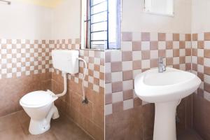 a bathroom with a toilet and a sink at Super Hotel O Sankaradeva Kalakshetra Formerly HK Residency in Dispur
