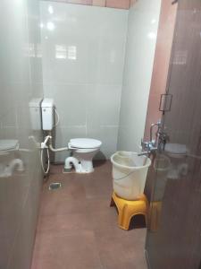 a bathroom with a toilet and a sink at Lovelynest homestay in Attigundi