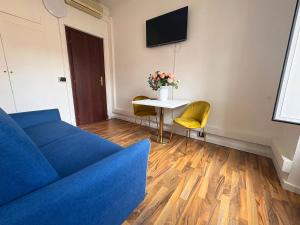 a living room with a blue couch and a table at Guest House Grazioli in Rome