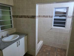 a bathroom with a sink and a window at Peaceful Accommodation in Durban