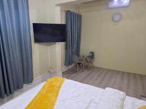 a bedroom with a bed and a flat screen tv at Peaceful Accommodation in Durban +29 photos