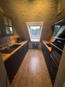 a kitchen with a sink and a window at Ruheoase Quickborn in Quickborn +7 photos