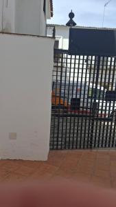 a white fence with a black gate at Ruralis Las Nogalas in Montánchez