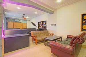 a living room with a couch and a table at Super Collection O Padshahi Bagh Formerly Matamal Cafe in Jawāharnagar