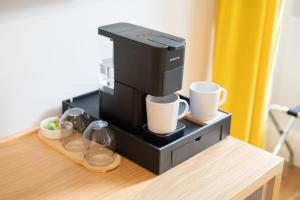 a coffee machine sitting on top of a table at A&S Suítes Coimbra in Coimbra