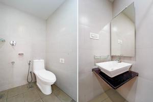 a white bathroom with a toilet and a sink at Super Collection O RTO Office Uzhavoor Formerly Hotel Zodiac in Puduveli