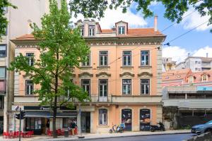 a large building on the corner of a street at A&S Suítes Coimbra in Coimbra
