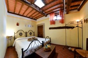 a bedroom with a bed and a table in it at Raggi di Sole in Cortona