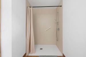a shower stall with a shower curtain in a bathroom at L'auberge le Toit Vert in Moutiers +56 photos