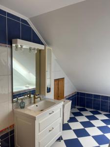 a bathroom with a sink and a mirror at Balatonalmádi Pipacs Villa in Balatonalmádi +14 photos