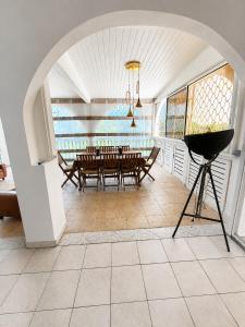 a dining room with a table and a tripod at La Mansarde in Le Robert