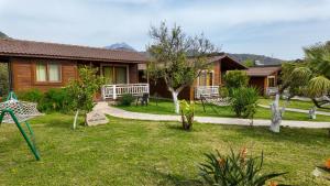 a house with a garden in front of it at Çıralı Villa 2 in Kemer