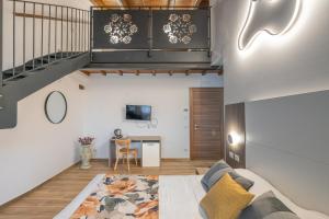 a loft apartment with a staircase and a living room at Agriturismo Santa Rosa in Lubriano