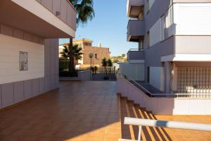 a walkway between two buildings with palm trees at SpainKarmaSun in Torrox Costa