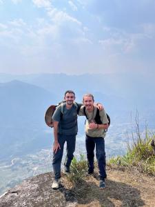 two men standing on the top of a mountain at The Happy Cozy Corner! in Lao Cai