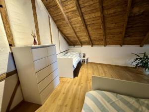 a bedroom with a bed in a room with wooden ceilings at Ferienscheune Rheingoldhof in Sankt Goar