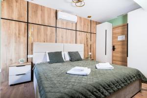 a bedroom with a bed with two towels on it at Vita Verde in Torrevieja