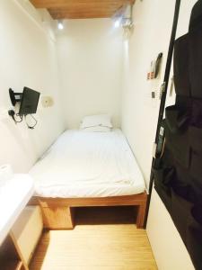 a small bedroom with a bed in a small room at In Inn in Hong Kong +20 photos