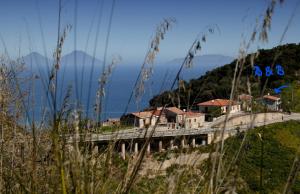 a bridge over a mountain with houses on it at B&B Gàttina in Naso