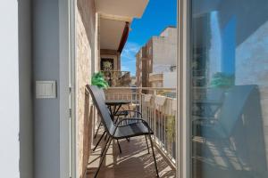 a balcony with a table and a chair on it at Vita Verde in Torrevieja