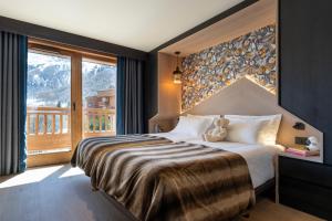 a bedroom with a bed with a teddy bear on it at Chalet Skadi - Village Montana in Val-d'Isère +122 photos