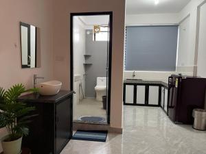 a bathroom with a toilet and a sink and a mirror at The Ashvem Horizon in Mandrem +125 photos