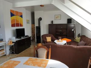 a living room with two couches and a tv at Ferienwohnung Irene in Bad Saulgau
