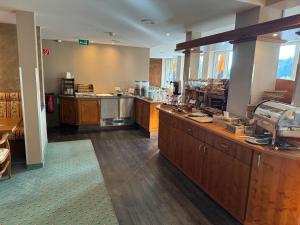 a large kitchen with wooden counter tops in a restaurant at Waldhaus am See in Willingen