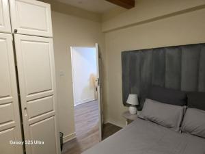 a bedroom with a bed and a door to a hallway at Skimbo's Apartment in Lusaka