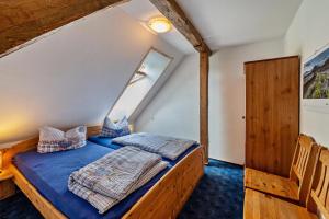 a bedroom with a bed in a attic at Dachstudio Seeblick in Krüselin