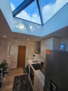 a kitchen with a large skylight in the ceiling at Bright luxurious Home in Oxford